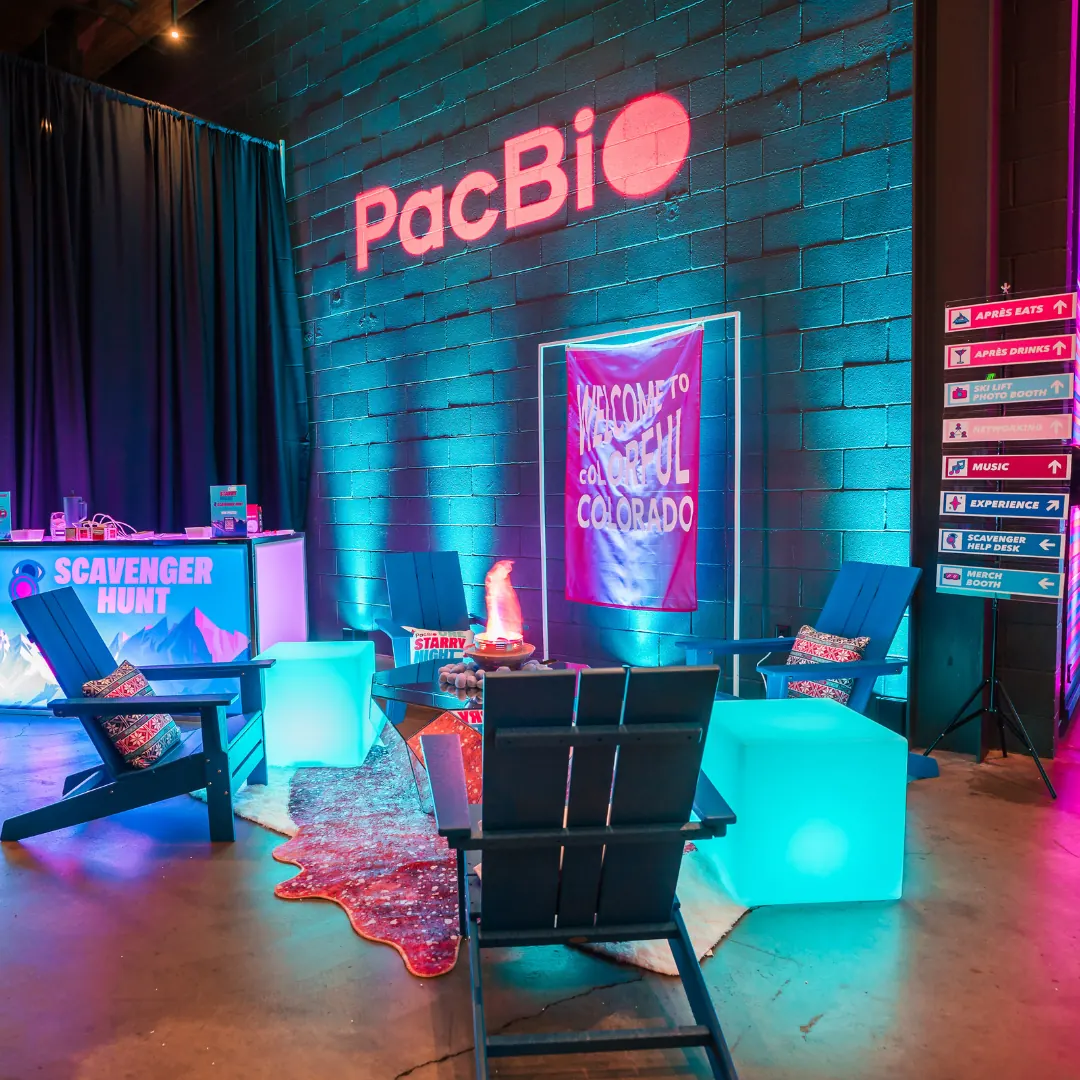 PacBio branded brick wall lounge with neon signage and ambient evening lighting