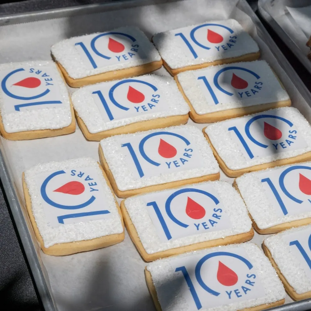 Decorated cookies marking a 10-year anniversary with a blood-drop logo