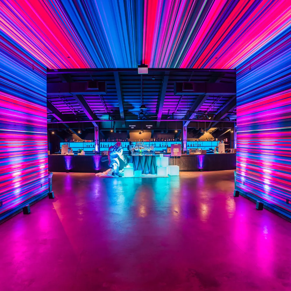 Neon-lit bar with purple and blue psychedelic lighting