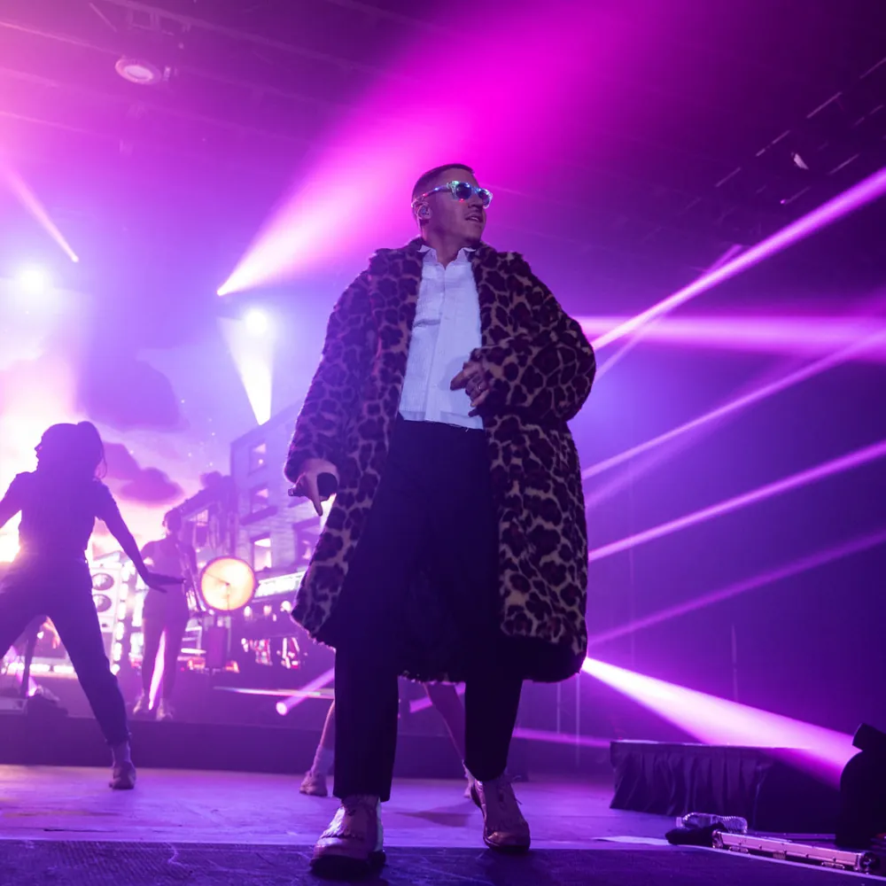 Macklemore performing on stage at a private client event in DC