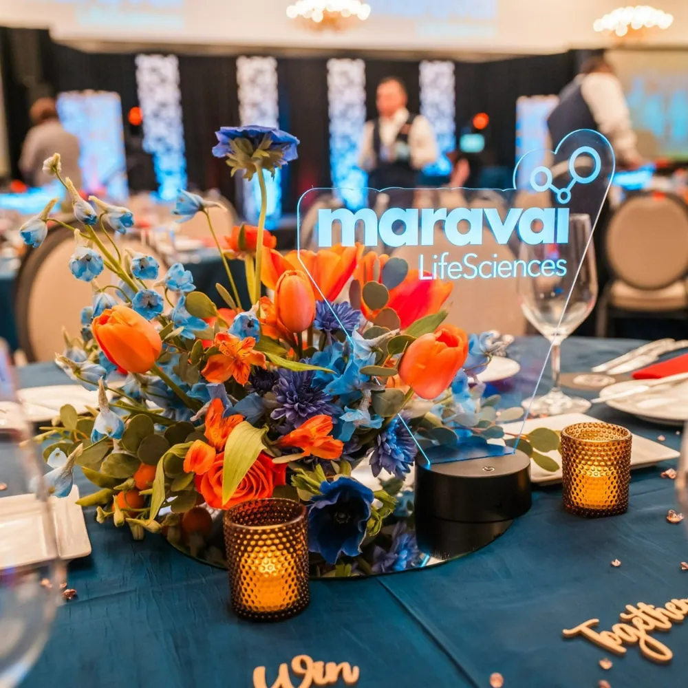 Maravai LifeSciences floral centerpiece with blue and orange flowers