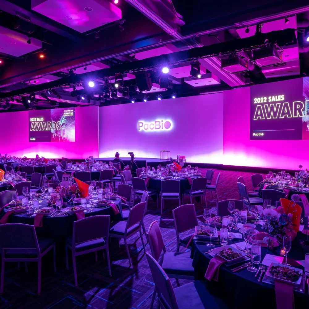 PacBio 2022 Sales Awards banquet hall in magenta and purple lighting