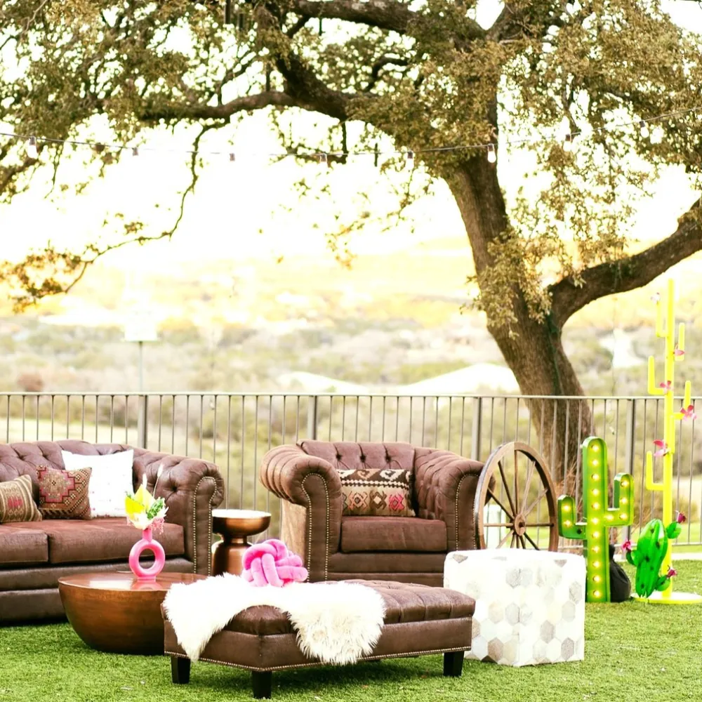 Outdoor western-themed patio with leather sofas and bright cactus decor